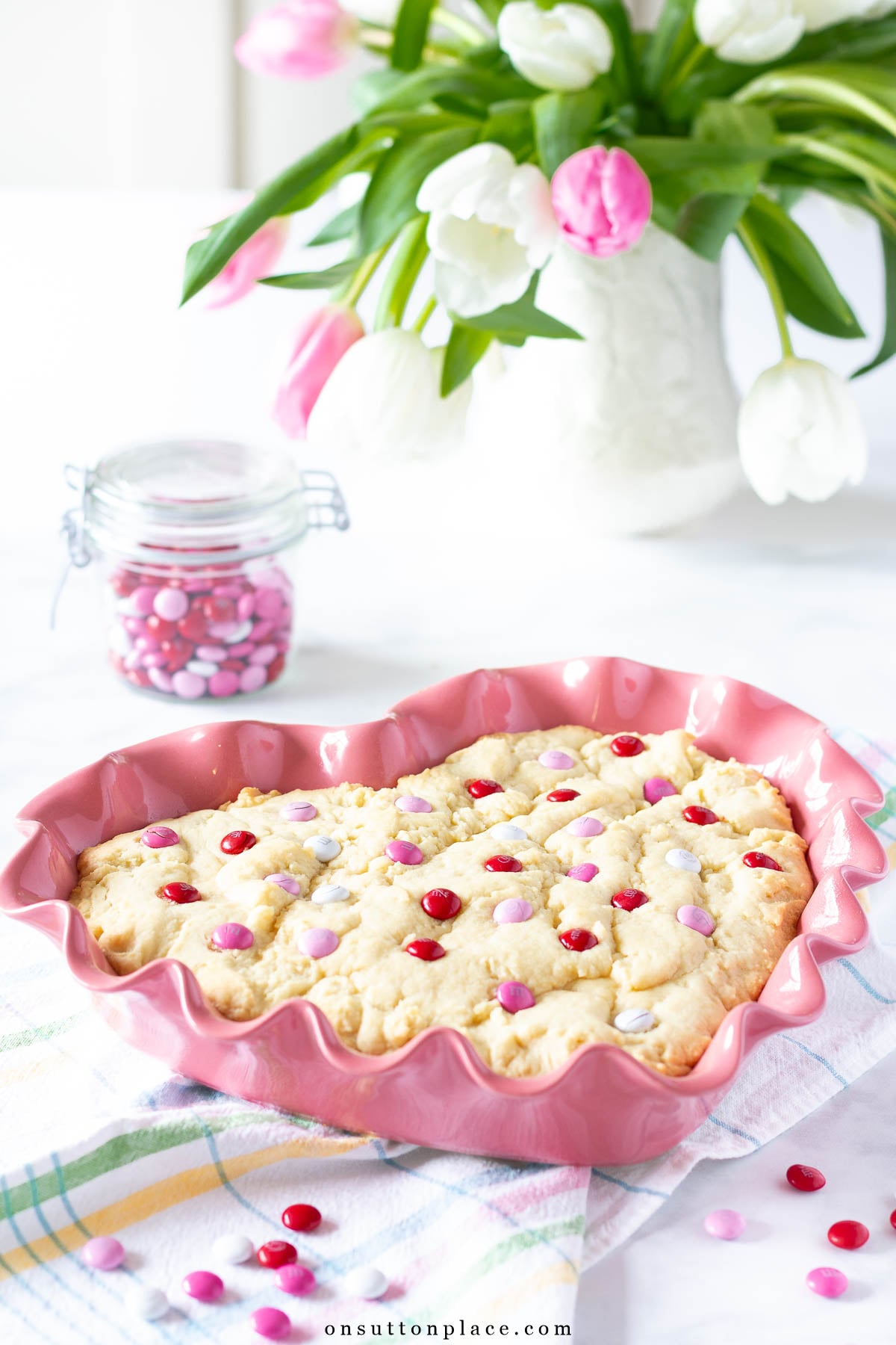 m&m cookie bars in heart baking dish