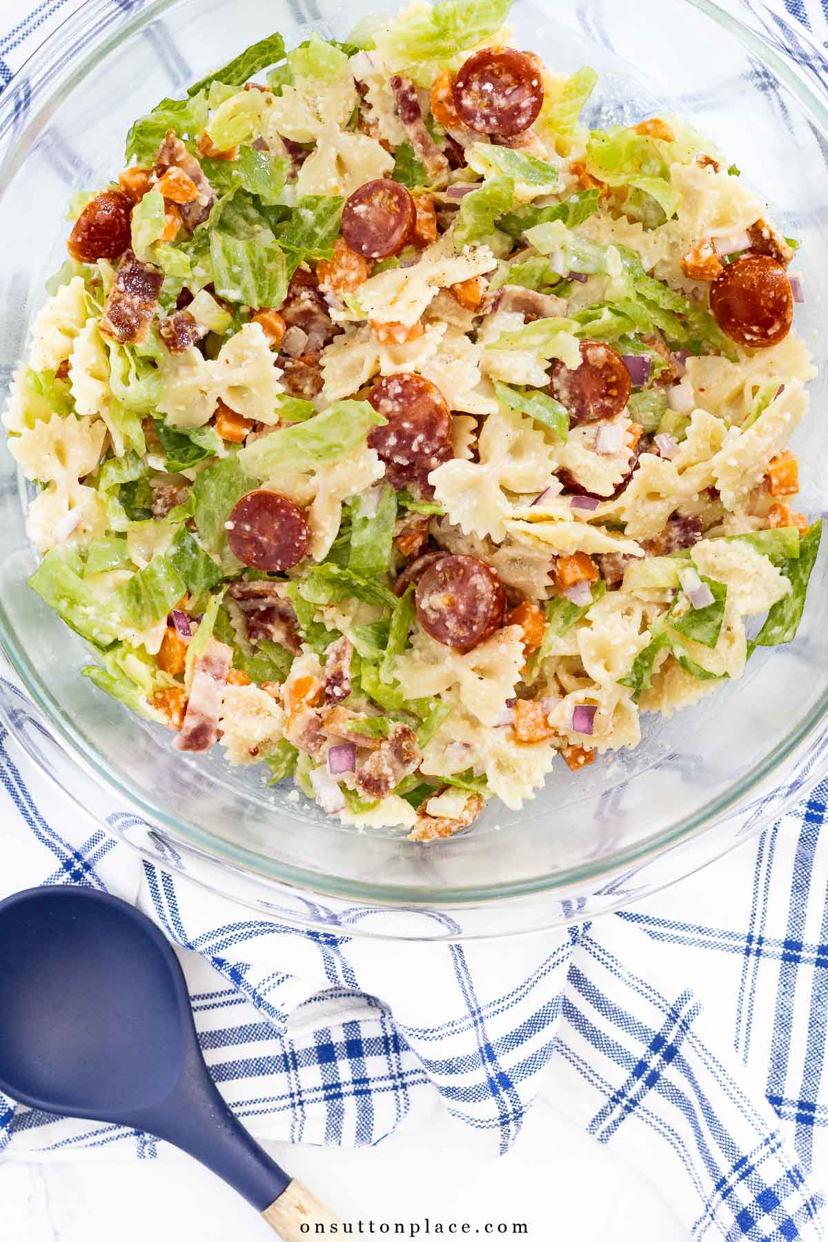 BLT pasta salad recipe with farfalle in bowl with large spoon