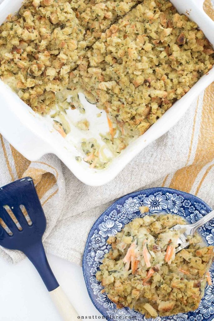 zucchini casserole recipe in baking dish with serving on a plate
