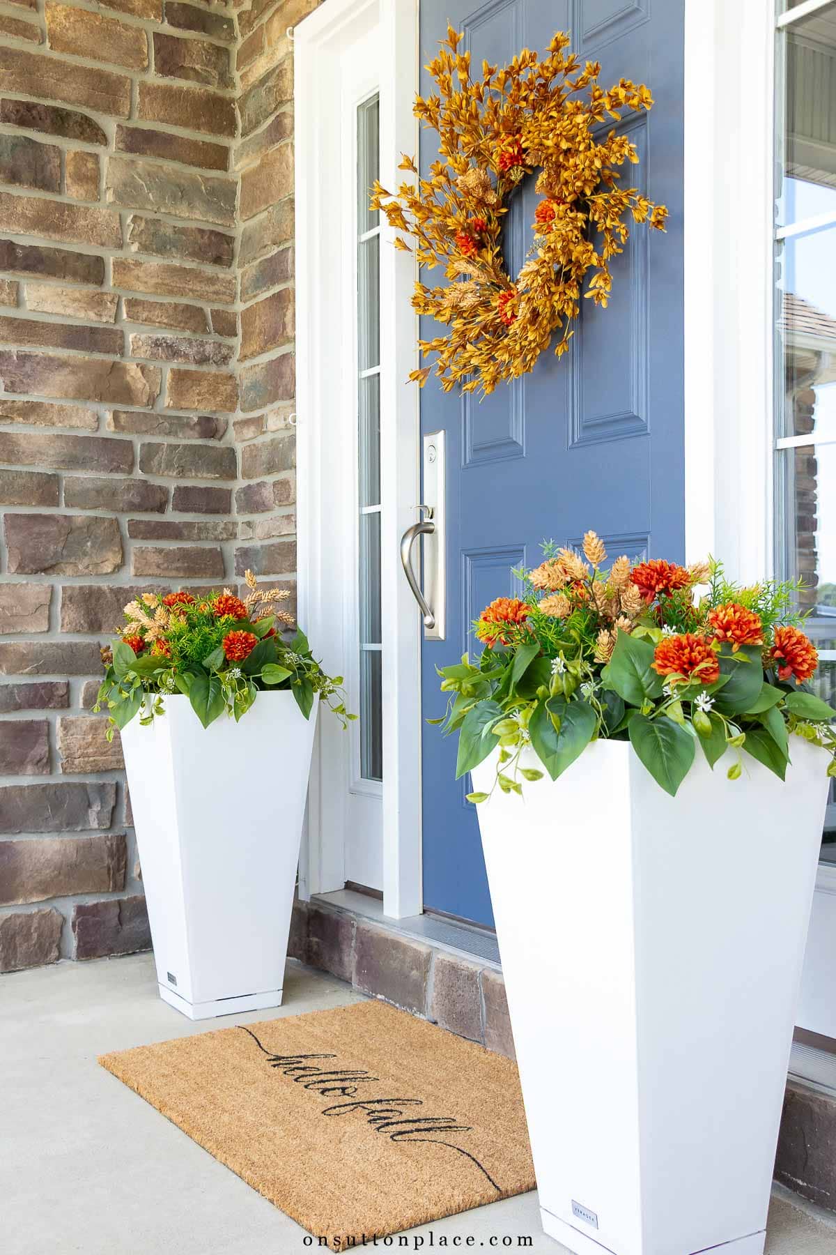 front porch decorating ideas blue door fall wreath white planter with faux plants doormat