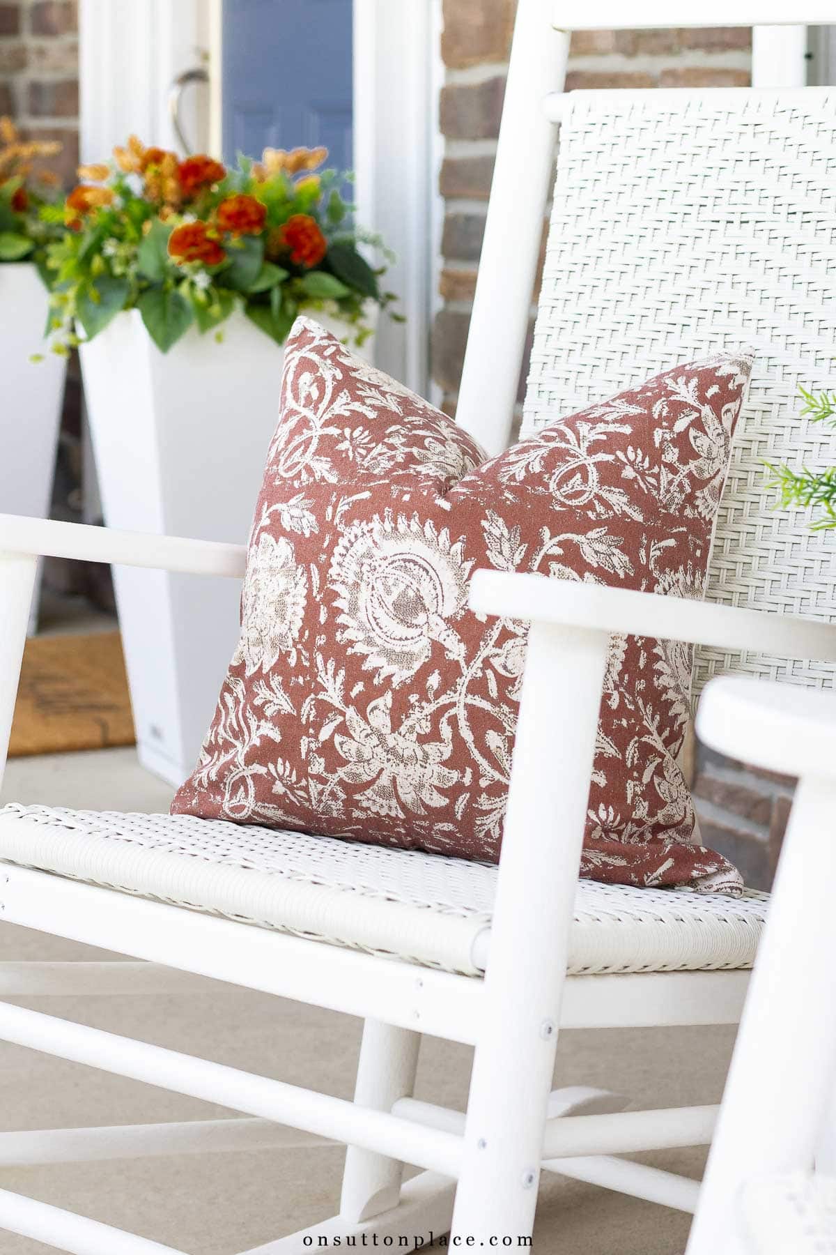 pillow in fall colors on rocker for fall porch decorating ideas