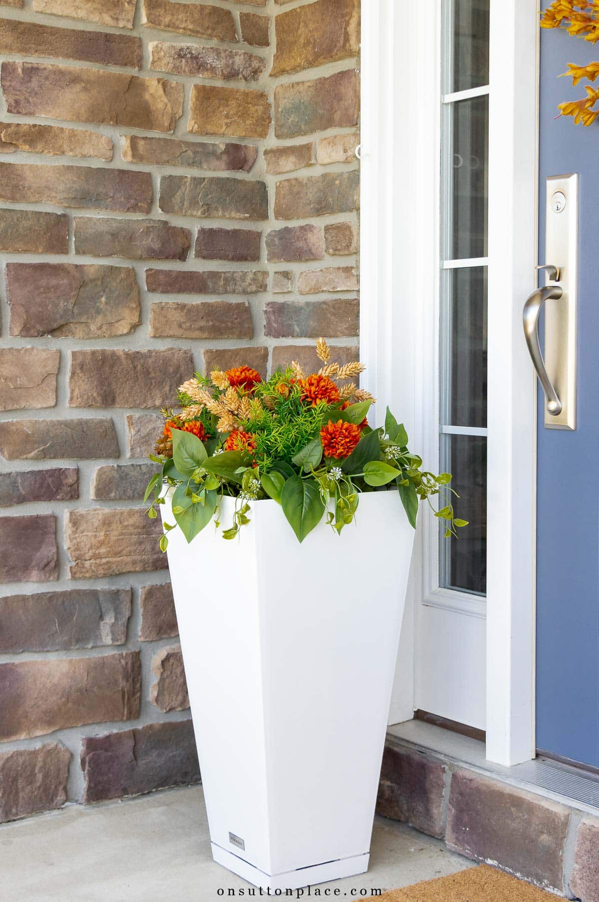 tall white planter with faux fall flowers faux greenery front porch decorating ideas