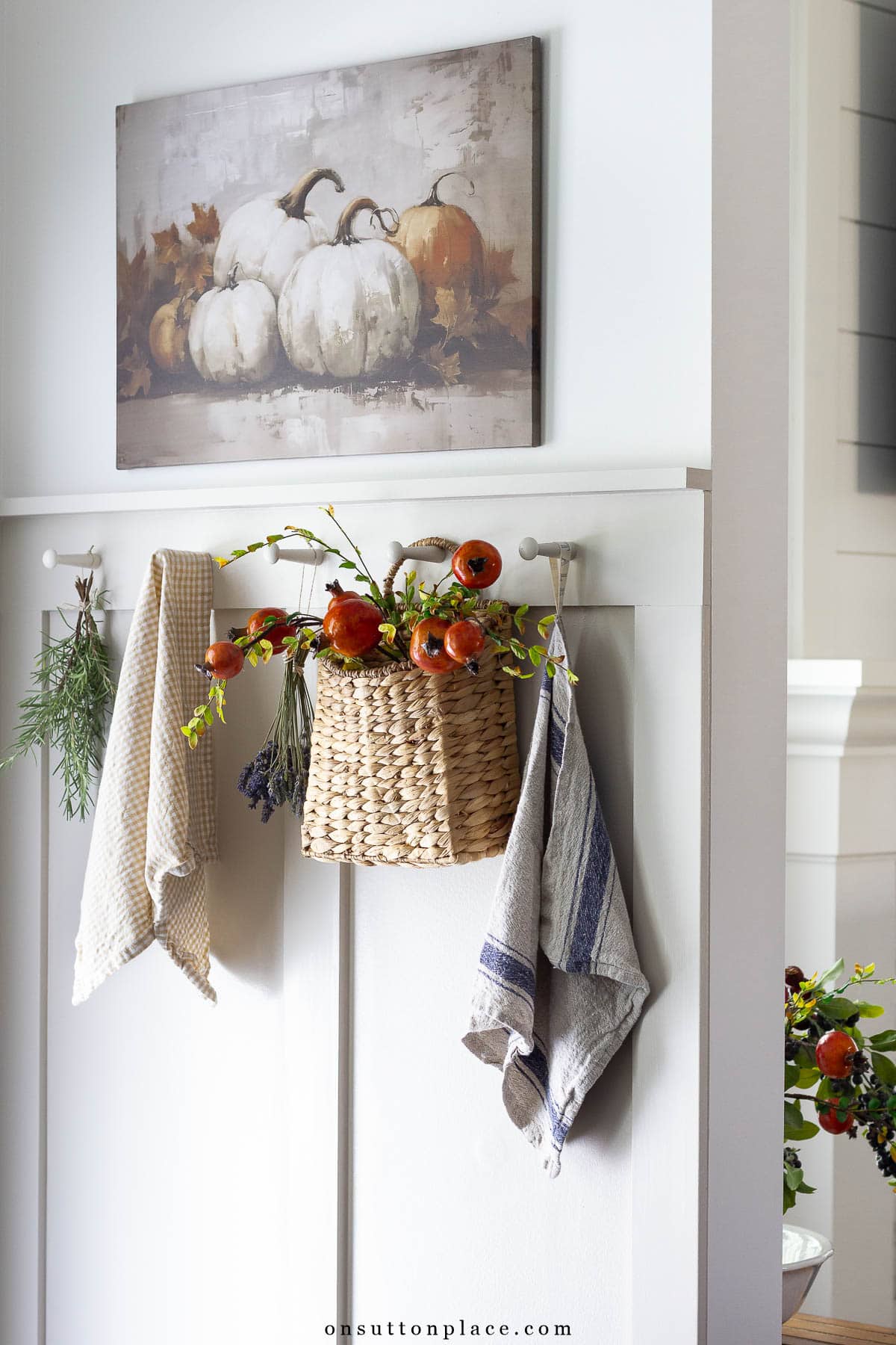 board and batten wall with shaker pegs decorated for fall