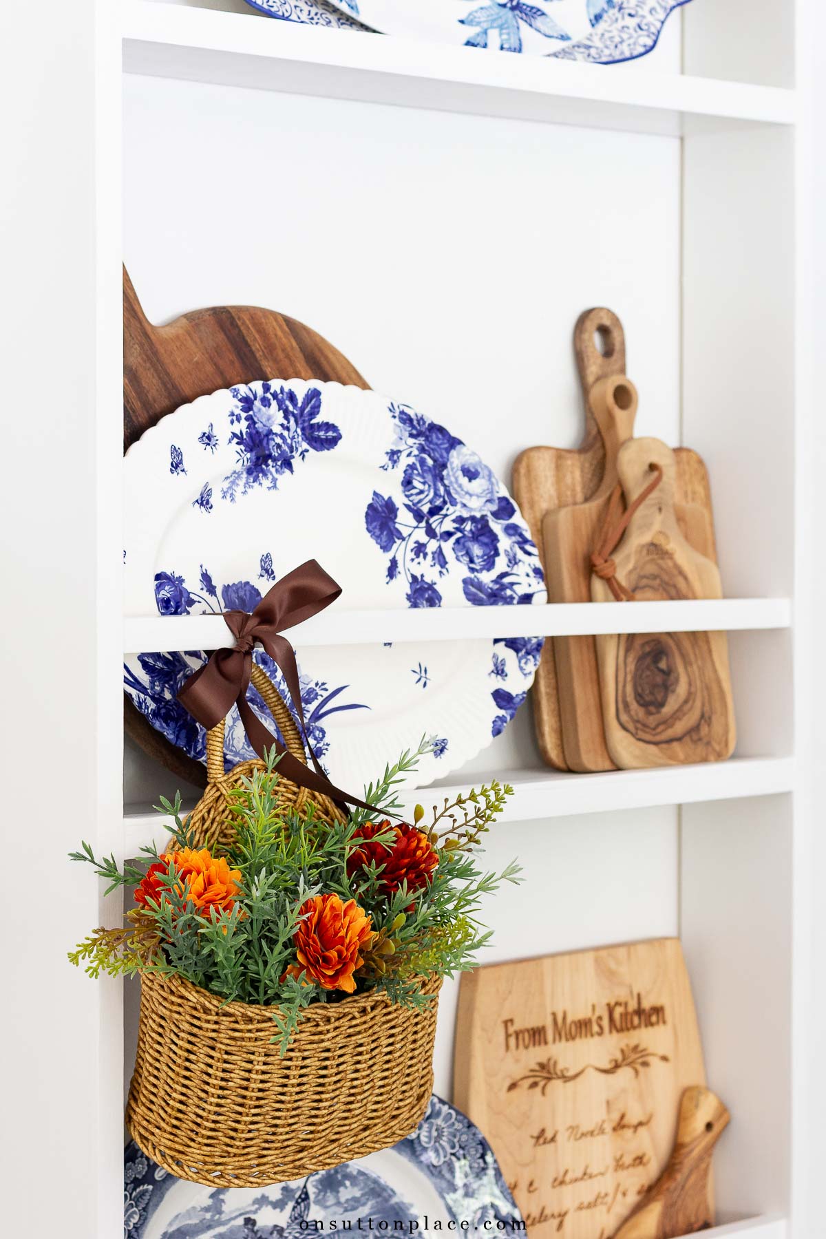 fall at home idea hanging basket tied to plate rack with ribbon