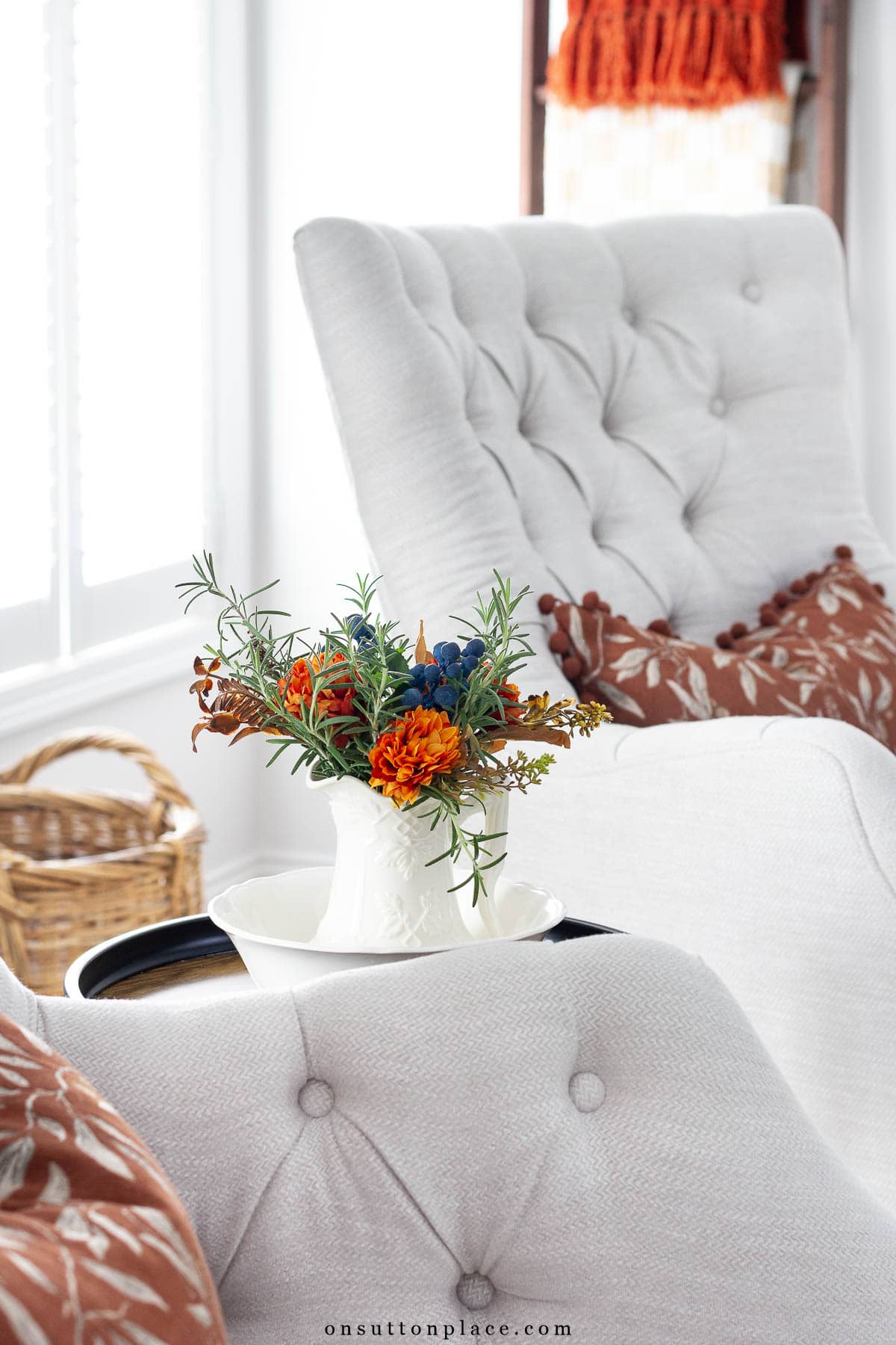 fall at home idea tufted chairs with rust ball fringe pillow covers small pitcher of rosemary with faux flowers
