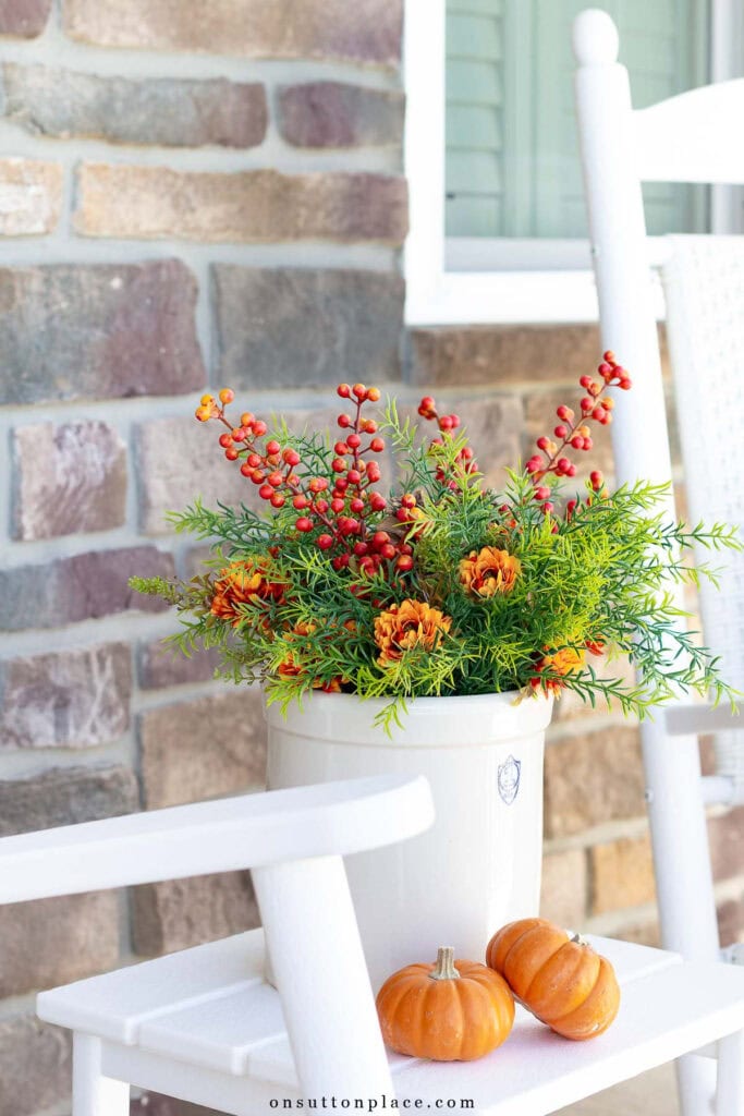simple fall porch decor crock of greenery and mums with mini pumpkins