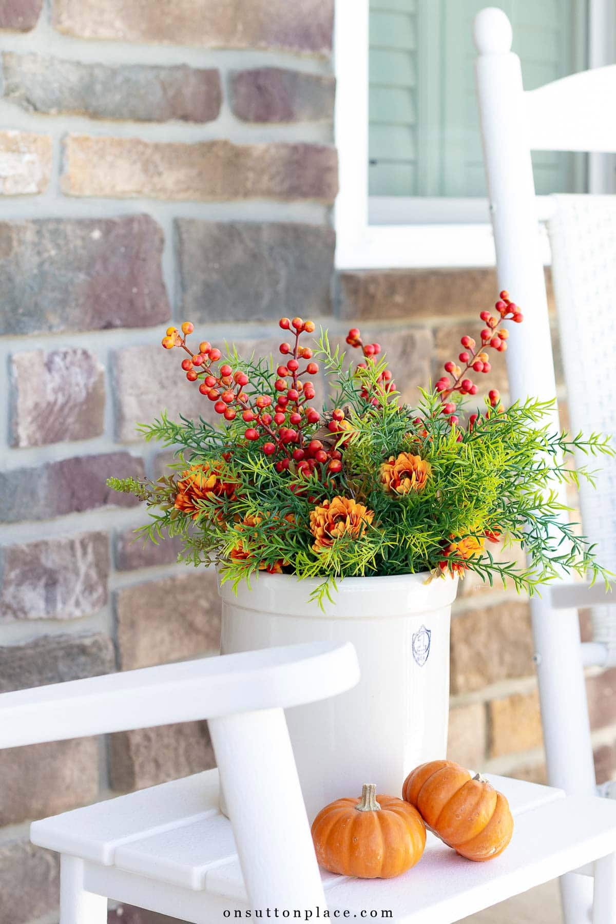 simple fall porch decor crock of greenery and mums with mini pumpkins